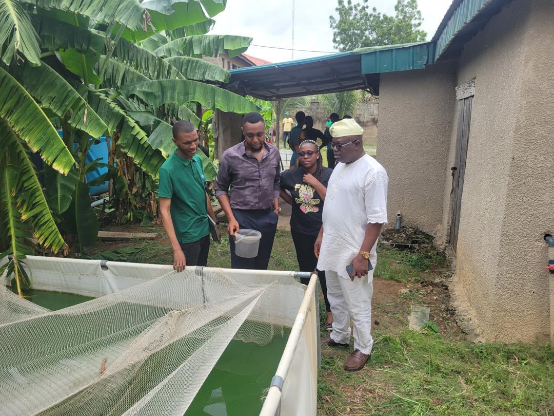 Dr. Akinwunmi taking a tour of the Aquaculture Entreprise